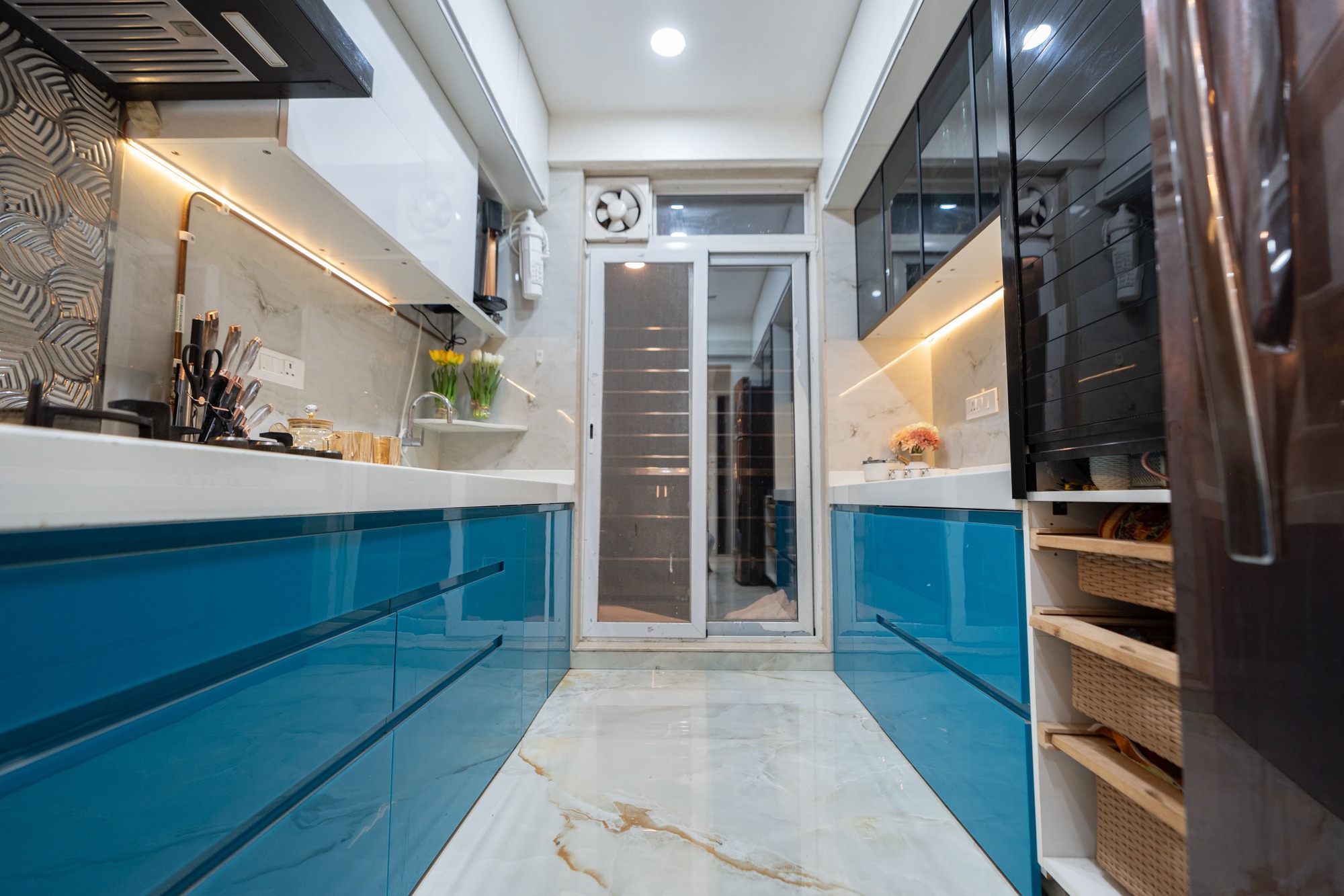 L-shape modular kitchen design with custom cabinetry by Indus Studio